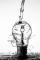 Our story black and white image of water pouring over a lightbulb